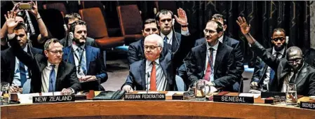  ?? KENA BETANCUR/GETTY-AFP ?? Vitaly Churkin, Russian ambassador to the U.N., votes Saturday at the Security Council on a Russian-Turkish peace plan for Syria. The resolution passed.