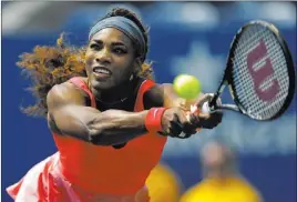  ?? PHOTOS BY KATHY WILLENS/ THE ASSOCIATED PRESS ?? Top-seeded Serena Williams returns a shot to Galina Voskoboeva of Kazakhstan during her second-round, straight-set victory at the U.S. Open in New York on Thursday.