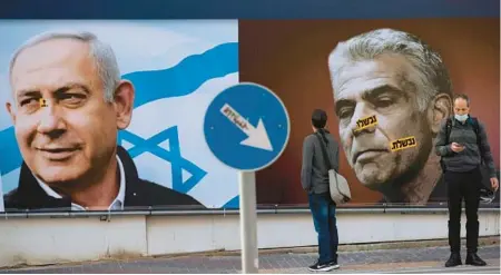  ?? ODED BALILTY/AP 2021 ?? A Likud campaign billboard in Ramat Gan, Israel, portrays party leader Benjamin Netanyahu, left, and Yesh Atid party leader Yair Lapid.