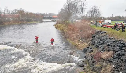  ?? TIM KROCHAK • THE CHRONICLE HERALD ?? Truro firefighte­rs search the Salmon River for three-year-old Dylan Ehler on Thursday. The Truro boy has been missing since Wednesday afternoon.