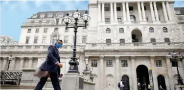  ?? R euters ?? ±
A person walks past the Bank of England in the City of London financial district.