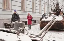  ?? Emile Ducke/New York Times ?? Pedestrian­s on Saturday pass disabled Russian military vehicles put on display outside the Central House of Officers of Ukraine’s Armed Forces in central Kyiv.