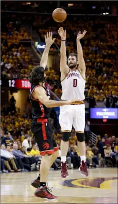  ?? AP PHOTO ?? FROM RIGHT: Cleveland Cavaliers’ Kevin Love shoots over Toronto Raptors’ Luis Scola, from Argentina, during the second half of Game 5 of the NBA basketball Eastern Conference finals Wednesday in Cleveland.