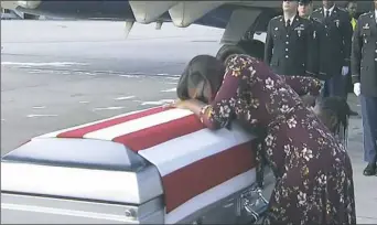  ?? WPLG via AP ?? Myeshia Johnson cries over the casket of her husband, Sgt. La David Johnson, who was killed in an ambush in Niger, upon his body’s arrival in Miami.