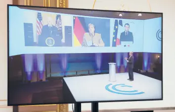  ?? BENOIT TESSIER/REUTERS ?? French President Emmanuel Macron, right on screen, attends a videoconfe­rence meeting Friday with President Joe Biden and German Chancellor Angela Merkel, center, ahead of the Munich Security Conference at the Elysee Palace in Paris.