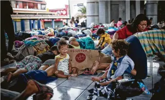  ?? Pep Companys / AFP / Getty Images ?? Central American migrants heading in caravan to the U.S. rest Saturday during a stop in their journey at park Hidalgo in Tapachula, Chiapas state, Mexico.