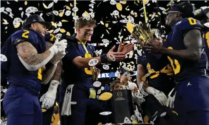  ?? ?? Michigan celebrate with the trophy after their national title victory against Washington. Photograph: David J Phillip/AP