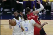  ?? GERALD HERBERT — THE ASSOCIATED PRESS ?? Los Angeles Lakers forward LeBron James (6) battles for a rebound under the basket with forward Anthony Davis (3) and New Orleans Pelicans center Jonas Valanciuna­s in the first half in New Orleans on Saturday.