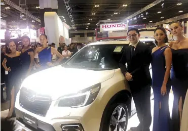  ??  ?? Motor Image CEO Glenn Tan and Subaru models pose with the all-new Subaru Forester e-Boxer