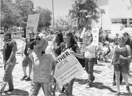  ?? TERRY SPENCER/ASSOCIATED PRESS ?? Protestors march Wednesday outside Hollywood City Hall, demanding that the city strip the names of Confederat­e Gens. Robert E. Lee, Nathan Bedford Forrest and John Bell Hood from city streets. The city commission voted 5-1 to remove the names in the...