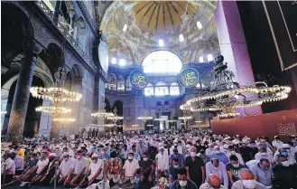  ?? YASIN AKGUL, THE ASSOCIATED PRESS ?? Worshipper­s pray inside the Byzantine-era Hagia Sophia, during afternoon prayers on Friday in Istanbul, Turkey.