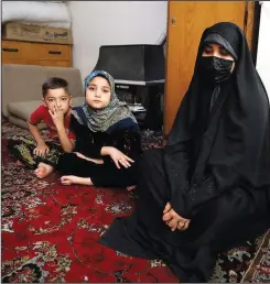  ?? ?? Afghan refugee Zahra Husseini and her children Salehe (center) and Shahrzad sit April 21 in their room in a poor suburb of Tehran, Iran.
(AP/Vahid Salemi)