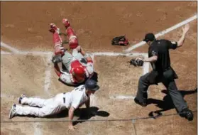  ?? GREGORY BULL — THE ASSOCIATED PRESS ?? San Diego Padres first baseman Wil Myers steals home, sliding in under the late tag by Phillies catcher Cameron Rupp during the fourth inning Wednesday.