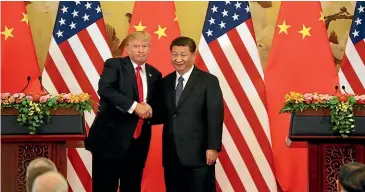  ?? AP ?? They shook hands in the Great Hall of the People in Beijing in November, but US President Donald Trump and his Chinese counterpar­t Xi Jinping are now on opposite sides of a potential trade war.