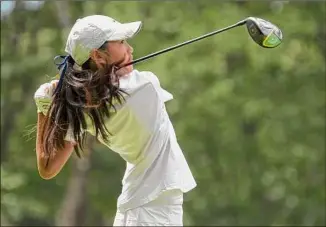  ?? Paul Buckowski / Times Union ?? Nina Choe of Ursuline School watches her tee shot on the eighth hole during the final round of the state girls' golf championsh­ip on Monday at Mcgregor Golf Links. Choe shot 75 on Monday and finished four shots behind Academy’s Kennedy Swedick.