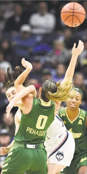  ?? Stephen Dunn / Associated Press ?? South Florida’s Enna Pehadzic (0) becomes entangled with UConn’s Molly Bent in the first half Sunday.