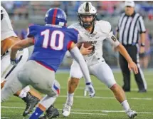  ?? STAFF PHOTO BY ERIN O. SMITH ?? Bradley Central quarterbac­k Dylan Standifer is stopped by Cleveland’s Jake Applegate (10) as he runs the ball Friday’s game at Raider Field. Standifer is 4-0 for his career against the Blue Raiders.