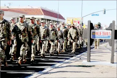  ?? PHOTO COURTESY OF U.S. ARMY ?? Troops march through the city of Old Town Barstow.