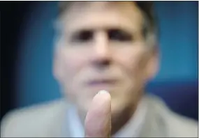  ?? — CP ?? Dr. Garth Webb holds a bionic lens on the tip of his finger, which he has worked to develop over the last eight years.