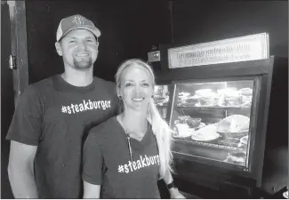  ?? SUSAN HOLLAND/WESTSIDE EAGLE OBSERVER ?? Dierek and Dani Madison pose beside the dessert case at the Station Cafe in Gravette. The Madisons opened the restaurant Aug. 24 and invite all in the area to come in, dine with them and sample a sweet treat from the tempting array of pies and brownies. Open hours for the business are 7 a.m. to 9 p.m. Monday through Saturday.