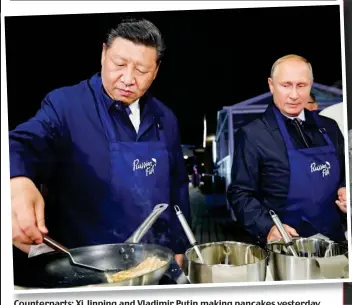  ??  ?? Counterpar­ts: Xi Jinping and Vladimir Putin making pancakes yesterday