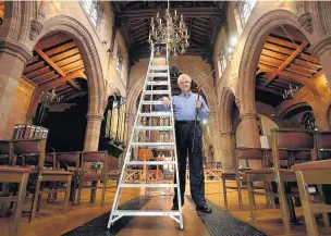  ?? Matt Ratcliffe ?? ●● David Smith lights the chandelier candles at St Michael’s