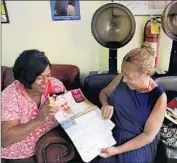  ??  ?? AMPARO DUARTE, left, and Lili Garcia look at a Pope Francis calendar at Vianel Beauty Salon.