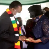  ?? ?? President Mnangagwa hands over the national flag to the late Major General (Retired) Godfrey Chanakira’s widow, Faina, at the National Heroes Acre