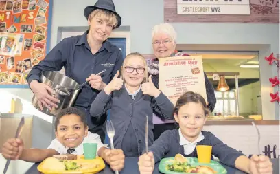  ??  ?? Giving the thumbs up to the Armistice Day menu at Castlecrof­t Primary School are pupils Erin Ashton, Romallo Fox and Maisie Simone-yeomans, school cook Sharon Spicer and Councillor Lynne Moran