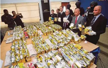  ?? BERNAMA PIC ?? Federal Narcotic Investigat­ion Department director Datuk Seri Mohmad Salleh (third from right) showing the seized syabu in George Town yesterday.