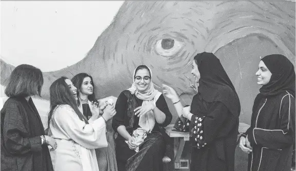  ?? PHOTOS: FOR THE WASHINGTON POST BY IMAN AL-DABBAGH ?? Salwa al-Dharrab, centre, founder of Nabt Fenjan, an all-women’s café in Riyadh, chats with friends and fellow baristas.