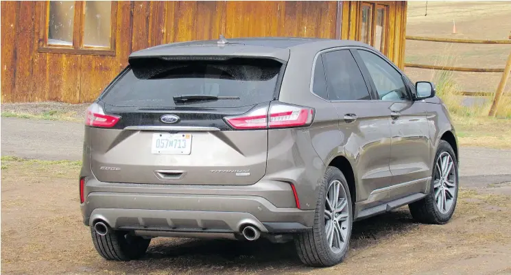 ??  ?? The rear of the redesigned Ford Edge Titanium features dual tailpipes, LED tail lights and a new lift gate. The front gets a new hood and wider grille