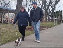  ??  ?? Josh and Christina Smith take their dog, Princess, for a walk through Blossom Heath Park on a recent fall afternoon.