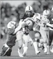  ?? Gabriella Angotti-Jones Los Angeles Times ?? GARFIELD’S P.J. Garcia tries to shake off a Roosevelt tackle in first-half action at East L.A. College.