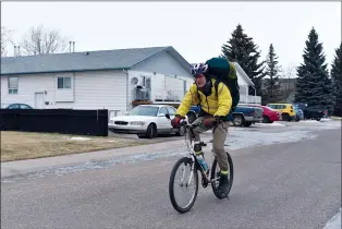  ?? NEWS PHOTOS MO CRANKER ?? Hatter John Whidden spent his Thursday biking around the city delivering coffee. He raised $800 for the local food bank and $400 for the Calgary Food Bank.