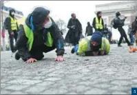  ?? RAFAEL YAGHOBZADE­H / AP ?? 5. Demonstrat­ors lie on the Champs-Elysees in Paris during a protest on Dec 8. 5