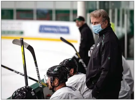  ?? (AP/Dallas Stars/Jeff Toates) ?? Dallas Stars interim head coach Rick Bowness watches practice Tuesday in Frisco, Texas. Bowness, 65, coached from behind the bench the first couple of days of training camp before lacing up his skates and getting on the ice. Montreal’s Claude Julien, 60, Edmonton’s Dave Tippett, 58, and others are confident in the NHL’s protocols as older, more at-risk people deal with the coronaviru­s pandemic.