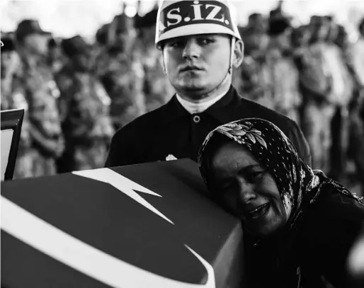  ?? BULENT KILIC / AFP / Gety Images ?? The mother of Turkish soldier Mehmet Yalcin Nane cries during the burial ceremony on Friday in Gaziantep. Turkish fighter jets bombed positions of Islamic State jihadists inside Syria as police arrested hundreds of suspected extremists after a wave of...