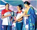  ?? ?? Captain Mitali Wickramage and vice captain Hayaa Hassen receiving the Marie Musaeus Higgins Trophy from Swarnamali wijesinghe