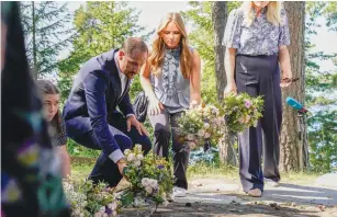  ?? (NTB/Torstein Boee/via Reuters) ?? CROWN PRINCE Haakon and Crown Princess Ingrid Alexandra lay flowers at a memorial on the island of Utoeya yesterday.
