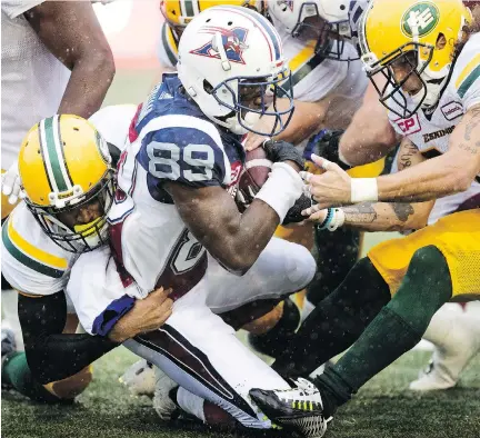  ?? ALLEN MCINNIS ?? Alouettes wide receiver T.J. Graham is tackled during Monday’s game against the Edmonton Eskimos. Despite a promising start that included a 15-0 lead, the Als ended up losing 42-24, which puts them officially out of contention for post-season play for...