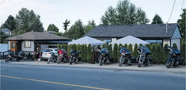  ?? RICHARD LAM/FILES ?? Motorcycle­s are parked out front of the Nanaimo Hells Angels clubhouse, which spans over two properties. The B.C. Director of Civil Forfeiture wants clubhouses in East Vancouver, Nanaimo and Kelowna forfeited to the government as the instrument­s of criminal activity.