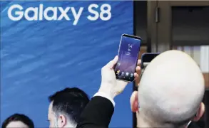  ?? PHOTO: REUTERS ?? Samsung unpacked . . . A new Galaxy S8 is forecast to help Samsung recover market share from Apple.