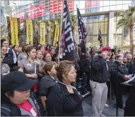  ?? DAMIAN DOVARGANES — THE ASSOCIATED PRESS ?? Unite Here Local 11Co-President Kurt Petersen, right at podium, congratula­tes hotel workers and leaders as he announces the ratificati­on results and unveiled the new contract terms at a news conference on the steps of the Interconti­nental Hotel downtown in Los Angeles on Monday.