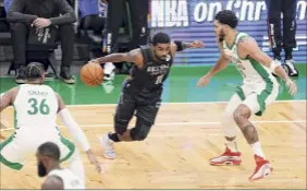  ?? Omar Rawlings / Getty Images ?? Brooklyn’s Kyrie Irving (11), who dropped a game-high 37 points on his former team, drives to the basket during the first quarter vs. the Celtics.