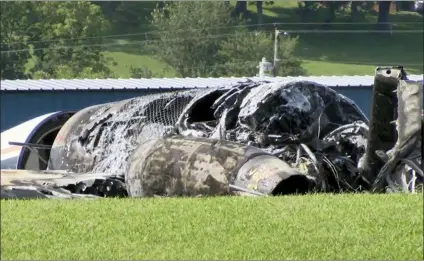  ?? WJHL TV VIA AP) ?? The burned remains of a plane that was carrying NASCAR television analyst and former driver Dale Earnhardt Jr. lies near a runway in Elizabetht­on, Tenn., on Thursday.