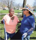  ?? RICK WOOD / MILWAUKEE JOURNAL SENTINEL ?? Jessie May Braggs (left) and Martha Bernice Love, residents of Garden Homes, chat as they participat­e in a neighborho­od clean up May 5.