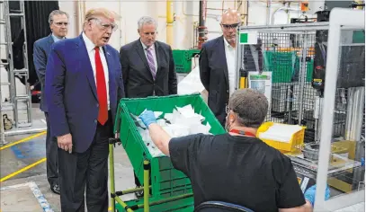  ?? Evan Vucci The Associated Press ?? President Donald Trump tours a Honeywell Internatio­nal plant Tuesday in Phoenix that manufactur­es personal protective equipment.