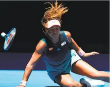 ?? David Gray / AFP / Getty Images ?? Fourth-seeded Naomi Osaka falls on the court in the second set against Hsieh Su-wei, but she recovered to win.