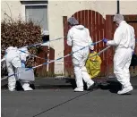  ??  ?? Probe: Forensics officers at scene